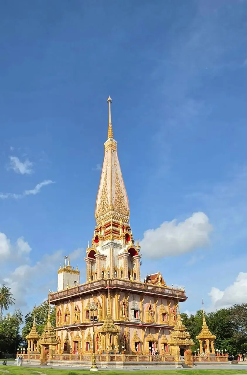 Golden temple spire against a blue sky in Phuket